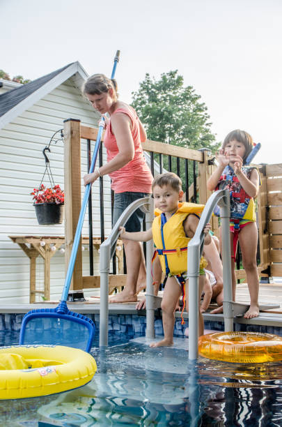 istock Parents and Mixed race (Chinese and caucasian) children entering in pool 1336403411