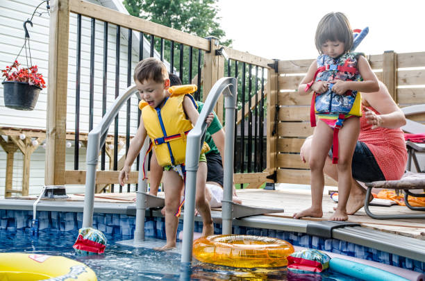 istock Parents and Mixed race (Chinese and caucasian) children getting ready for pool 1336404035