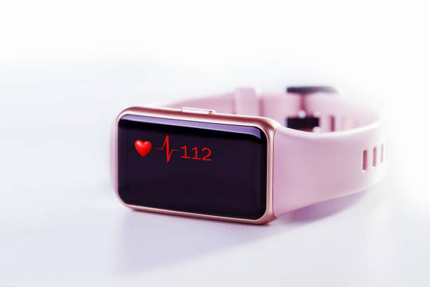 istock Close up white smart watch with health app icon on the screen on light grey surface. 1336404931