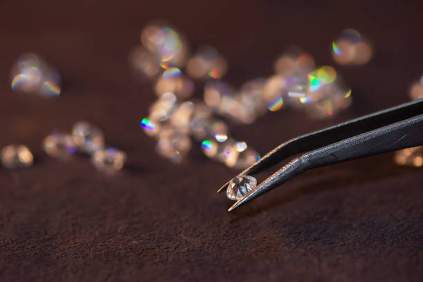 istock Diamond with tweezers and magnifier.Gemstone Beauty 1336406095