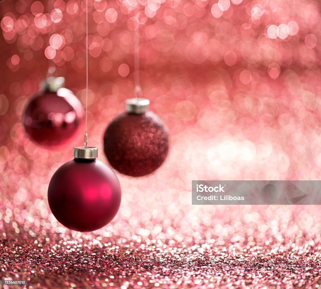 Christmas Red Baubles on a Red ackground Christmas Red Baubles on a Glittery Red Background. Very shallow depth. Backgrounds Stock Photo