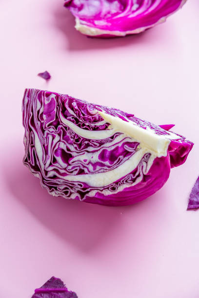 istock A quarter of purple cabbage on pink  background. 1336407738