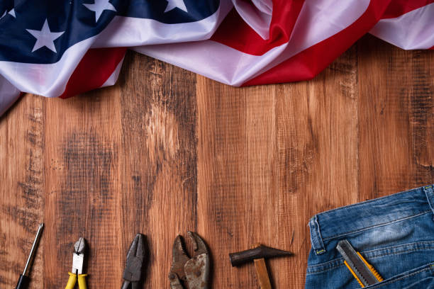 istock Top view design concept of Labor Day with working tools and jeans. 1336408725