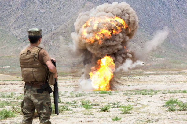 istock Army Soldier standing against explosion in battlefield 1336408843