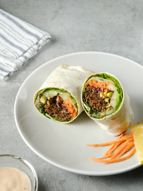 istock Salad Wrap. Tortilla wraps with beef teriyaki and fresh vegetables. 1336411964