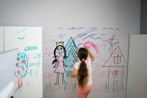 Little Child Girl Drawing. Cute Kid Having Fun