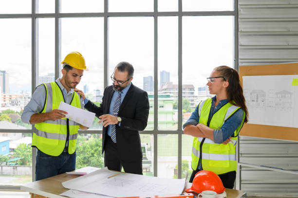istock Engineers team meeting for architectural project. architects discussing blueprint with construction manager in office worker conference site. Construction Concept 1336414531