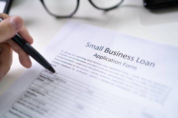 istock Person Hand Over Small Business Loan Application 1336414623