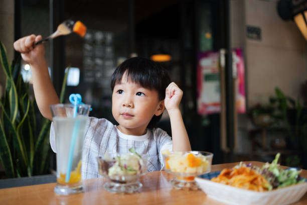 istock Little boy eating in restaurant 1336415835