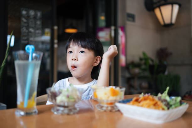 istock Little boy eating in restaurant 1336415838