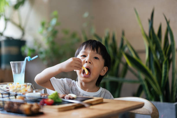 istock Little boy eating in restaurant 1336416374