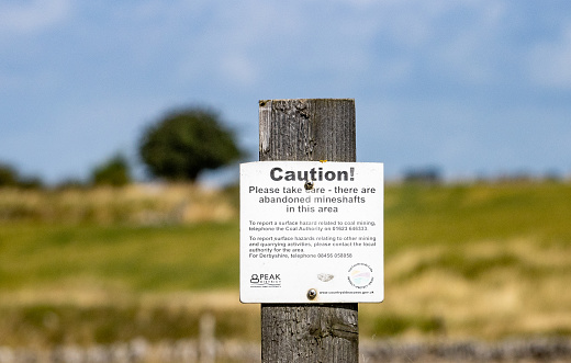 Warning Sign in Magpie Mine in Peak District National Park, England, with contact details visible