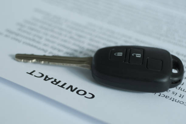 istock A contract with a car key on the table. 1336418224