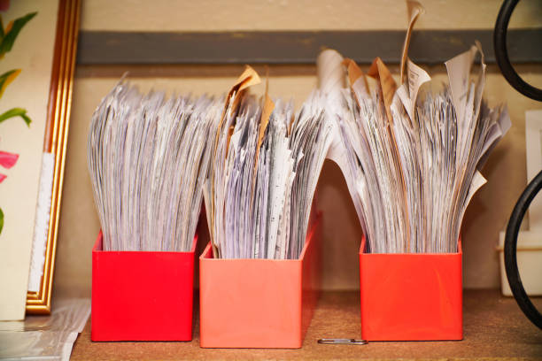 Old documents and business papers in boxes on a shelf in the archive Old documents and business papers in boxes on a shelf in the archive. Selective focus filing cabinet stock pictures, royalty-free photos & images