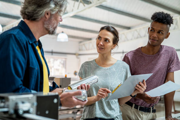 istock Female and male colleagues working on recycled materials while standing inside sustainable plant 1336419146