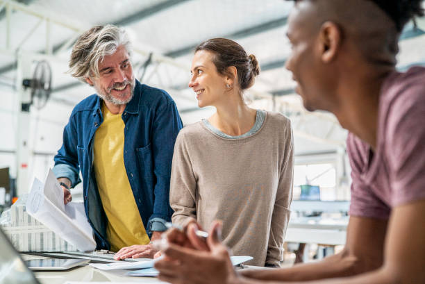 istock Multi ethnical group of colleagues sharing ideas inside sustainable factory 1336419191