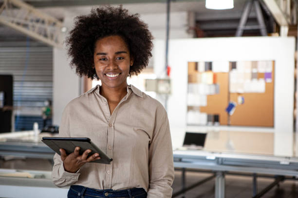 istock Portrait of smiling distribution warehouse female worker standing at workplace 1336419306