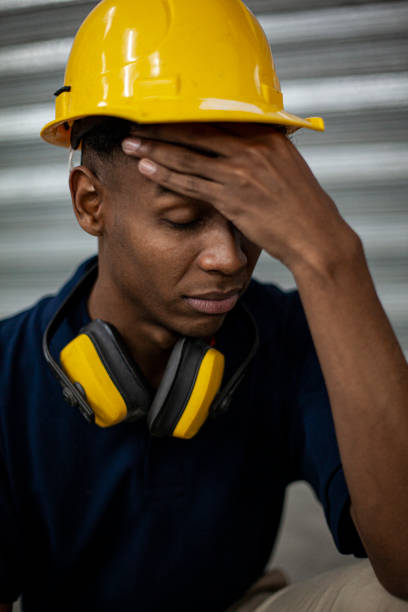 istock Portrait of blue collar operator having a headache during daytime 1336419431