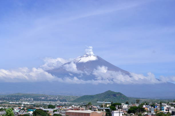 Active Popocateptl volcano in Mexico with snow viewed from Atlixco Active Popocateptl volcano in Mexico with snow viewed from Atlixco Puebla popocatepetl volcano photos stock pictures, royalty-free photos & images