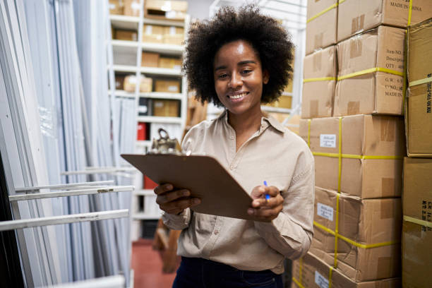istock Female storage room operator checking on stock in shelves 1336420189