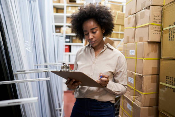 istock Female storage room operator checking on stock in shelves 1336420191
