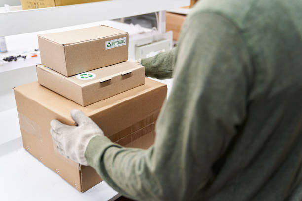 istock High angle of male and distribution warehouse operator holding cardboard boxes 1336420215