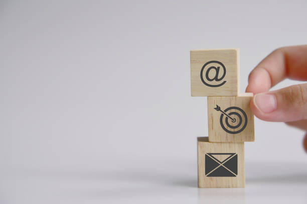 istock Hand putting wooden block cube symbol target, email, address. Website page contact us or e-mail marketing concept 1336426147