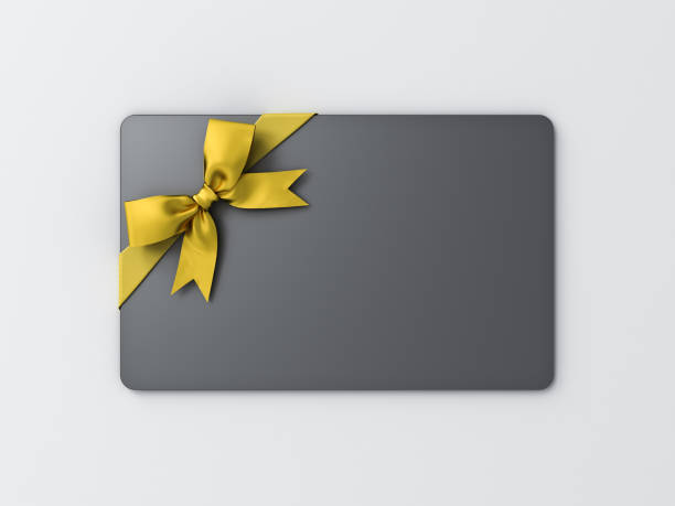 istock Blank black gift card with gold ribbon bow isolated on white background with shadow minimal concept 1336428339