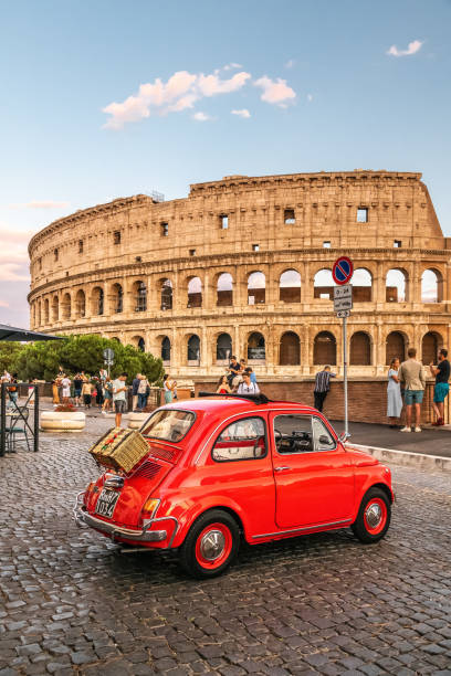 Little red old Fiat 500 in front of coliseum at sunset Rome, Italy 17.07.2021: Little red old Fiat 500 in front of coliseum at sunset with picnic basket on rear little fiat car stock pictures, royalty-free photos & images