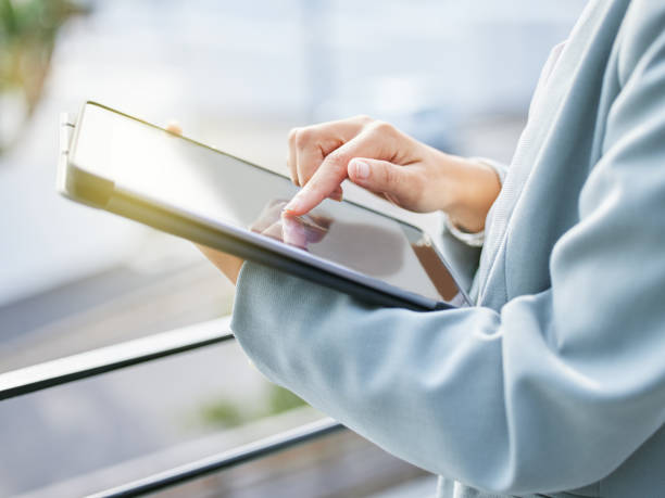 istock Shot of an unrecognizable businesswoman using a digital tablet at work 1336443760