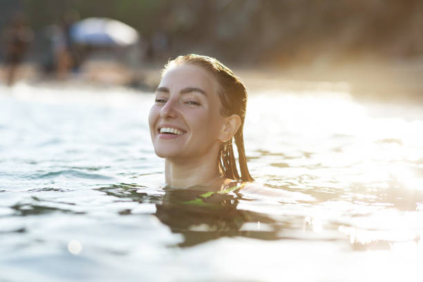 istock Woman having fun in the sea 1336446934