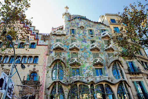 Barcelona, ​​Spain - November 29,2013: Casa Batlló.\nAmong the attractions of Barcelona, ​​this house stands out primarily for its architecture. Part of the facade is covered with mosaics. The most remarkable feature of the Casa Batlló is the almost complete absence of straight lines in its design. Architecture by Antoni Gaudi.