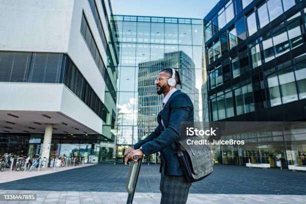 Attractive Casual Business Man Getting To Work Stock Photo - Download Image Now - Push Scooter, Electricity, Motor Scooter