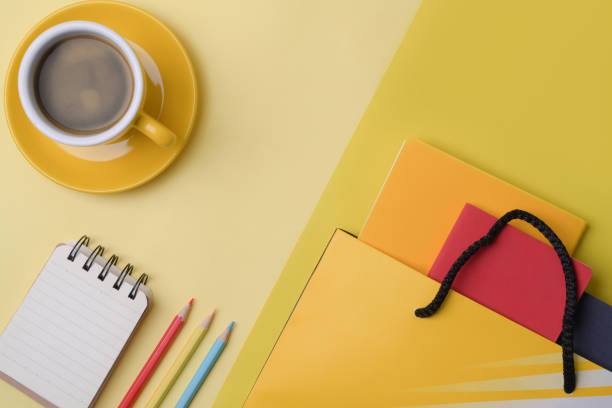 istock Stationery, notebook, coffee cup and bag on yellow background. 1336448166