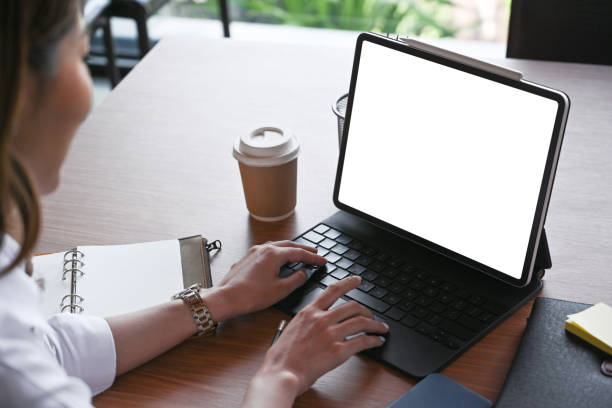 istock Cropped shot young woman working with computer tablet at cafe. 1336449203