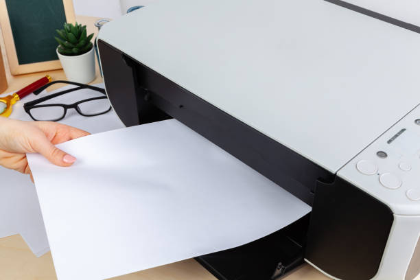 istock Hands of a woman using a copying machine close up 1336449207