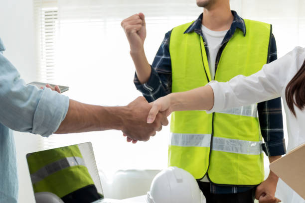 istock contractor team handshake with customer after business meeting start up project contract in construction site office building, business partnership, engineering, cooperate business, teamwork concept 1336449492