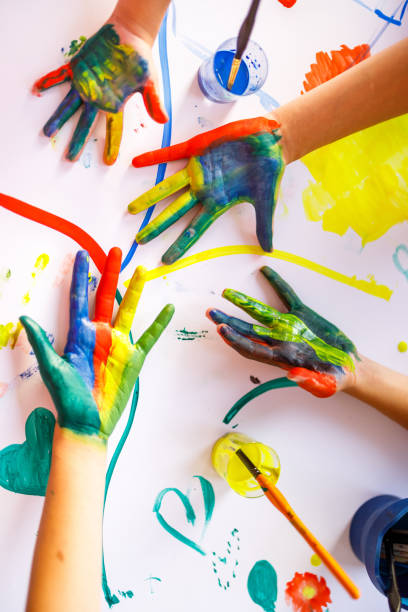 istock Children's hands covered whit watercolors 1336449612