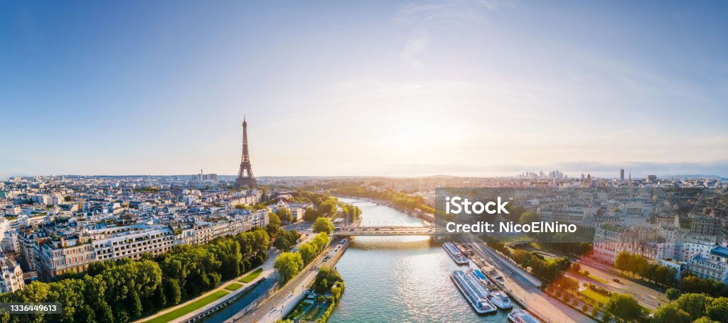 Paris aerial panorama with river Seine and Eiffel tower, France. Romantic summer holidays vacation destination. Panoramic view above historical Parisian buildings and landmarks with blue sky and sun Paris - France Stock Photo
