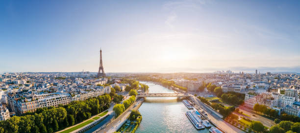 paris aerial panorama with river seine and eiffel tower, france. romantic summer holidays vacation destination. panoramic view above historical parisian buildings and landmarks with blue sky and sun - france imagens e fotografias de stock