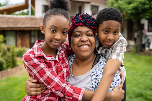 istock A single mother with two children looking at camera and smiling 1336450192