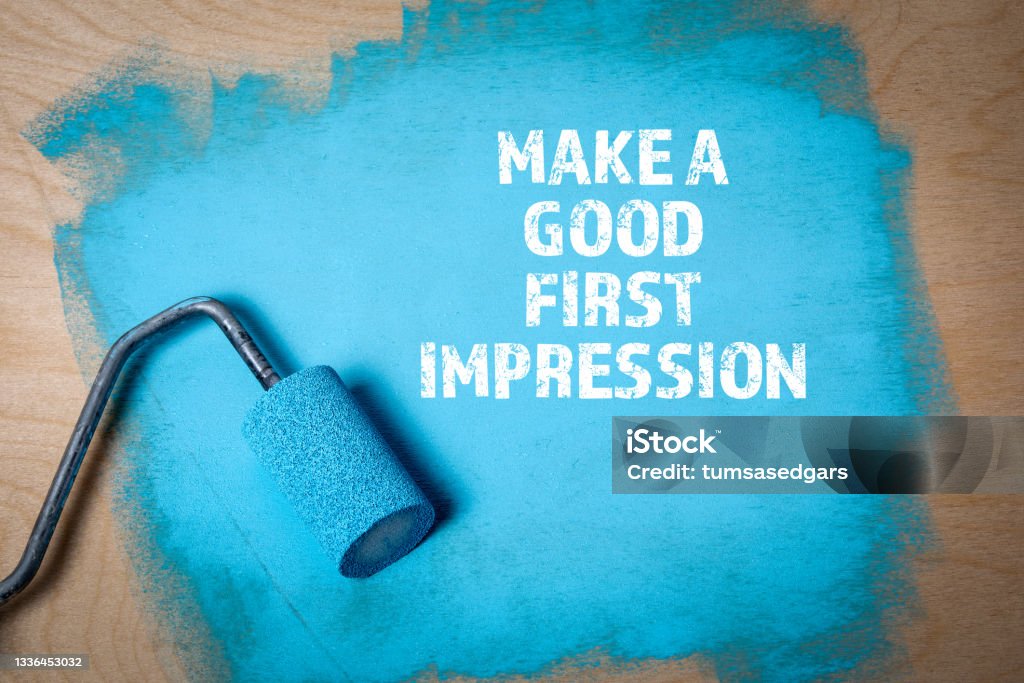 Make a Good First Impression. Paint roller with blue paint on a wooden surface Make a Good First Impression. Paint roller with blue paint on a wooden surface. Beginnings Stock Photo