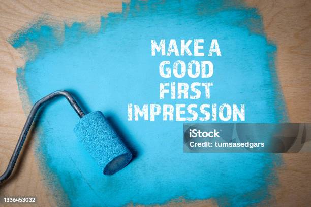 Make A Good First Impression Paint Roller With Blue Paint On A Wooden Surface Stock Photo - Download Image Now