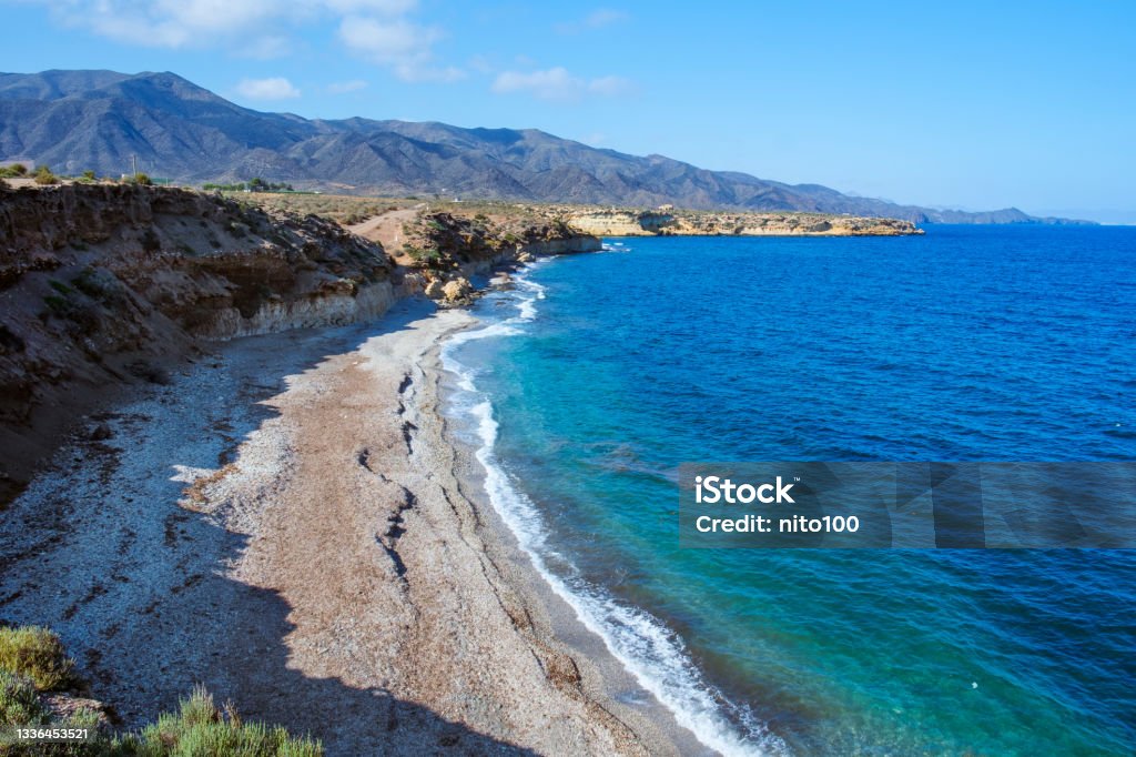 Playa Larga beach in Lorca, Spain a view over Playa Larga beach, in Lorca, in the Costa Calida coast, Region of Murcia, Spain, with the Calnegre mountain range in the background Lorca Stock Photo