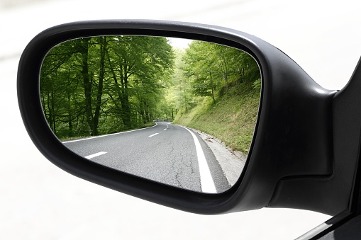 rearview car driving mirror view green forest road