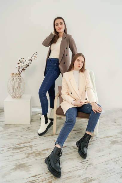 istock Two young women wearing blazers on white. 1336456965