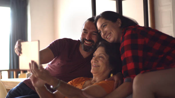 istock Family doing a video call on digital tablet at home 1336457580