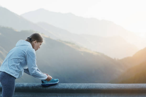 istock Sport runner woman tying laces before training. Marathon. 1336457581