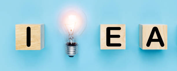 istock idea and new creative thinking concept, light bulb with idea word on wood block on blue background 1336457736