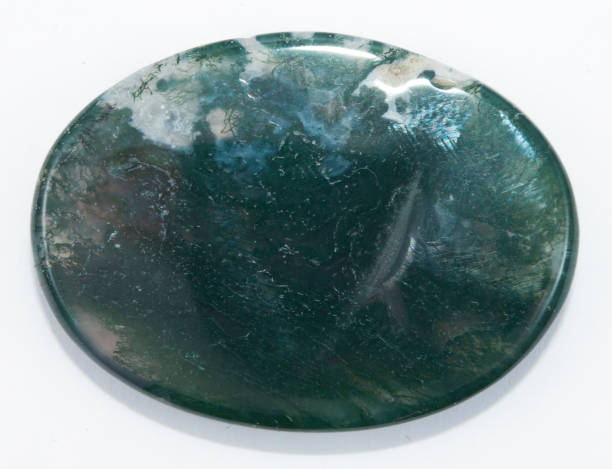 Natural moss agate oval cabochon on the white background Natural moss agate oval cabochon on the white background agate stock pictures, royalty-free photos & images